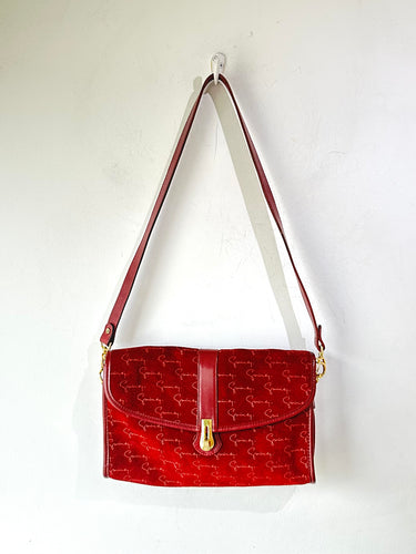 Red handbag with gold accents on a white background