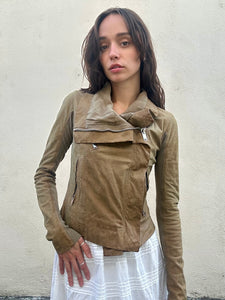 Woman wearing a brown jacket against a plain background