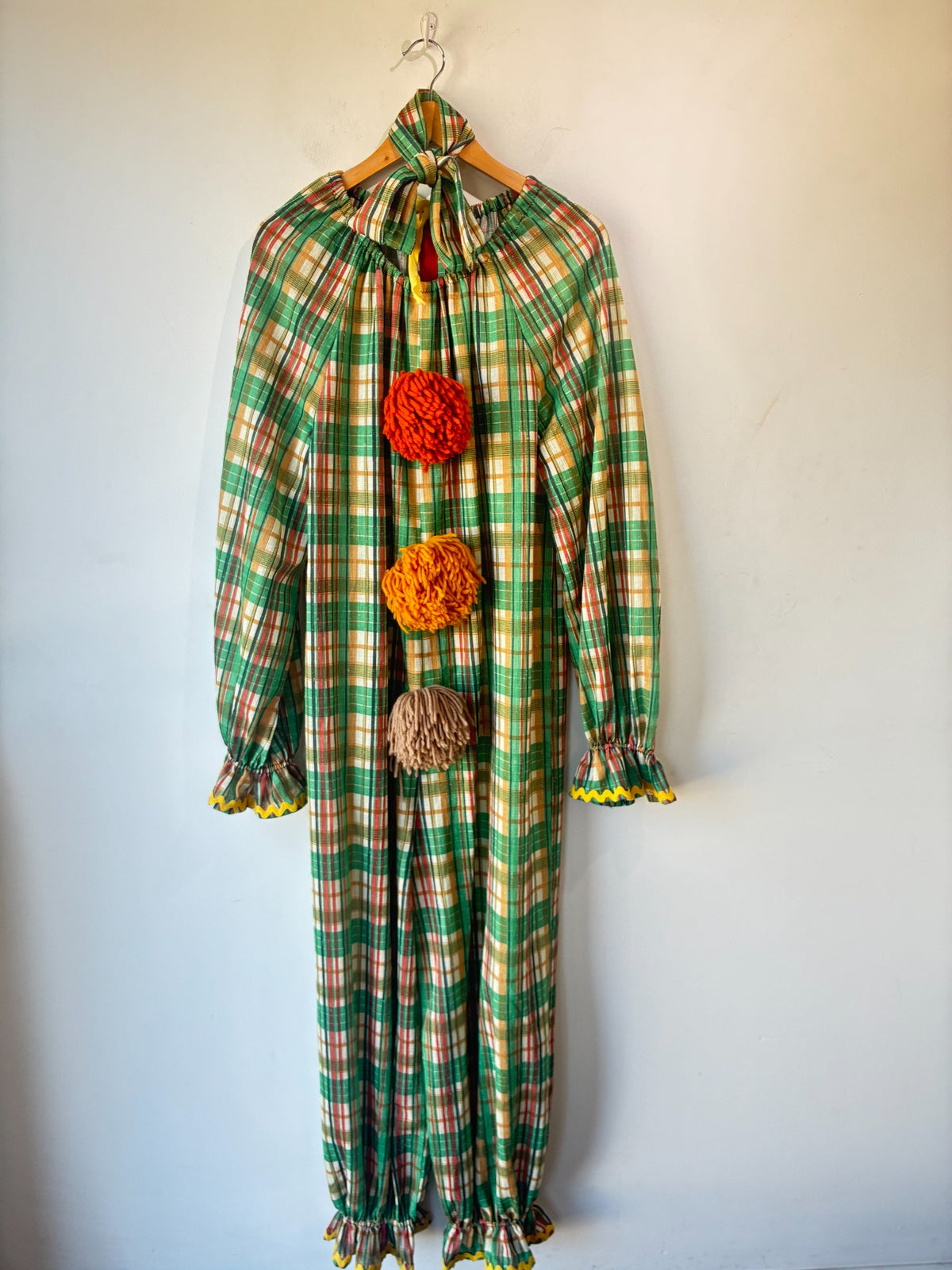 Vintage handmade plaid clown costume with yarn pom-poms and yellow rickrack